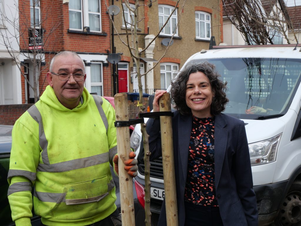 Councillor Deirdre Costigan and a tree contractor standing next to a newly planted street tree.