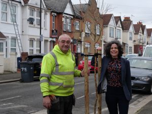 Councillor Deirdre Costigan and a tree contractor standing next to a newly planted street tree.
