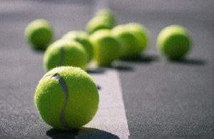 Yellow tennis balls on a grey surface