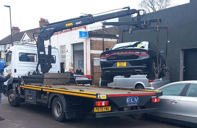 Car being lifted on to a tow truck