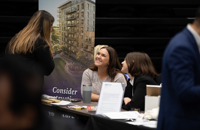 Employers talking to candidates at a jobs fair