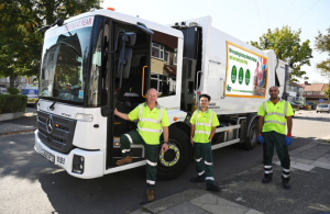 Three men in Greener Ealing uniforms in front of a waste collections truck