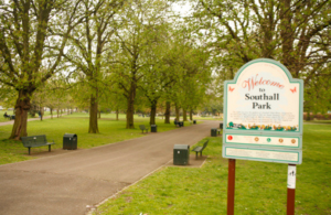Entrance of Southall Park with a welcome sign and trees