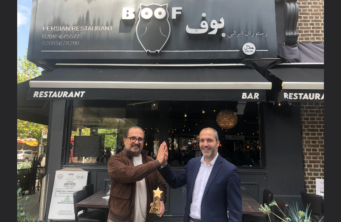 Councillor Bassam Mahfouz presenting trophy to Boof restaurant owner