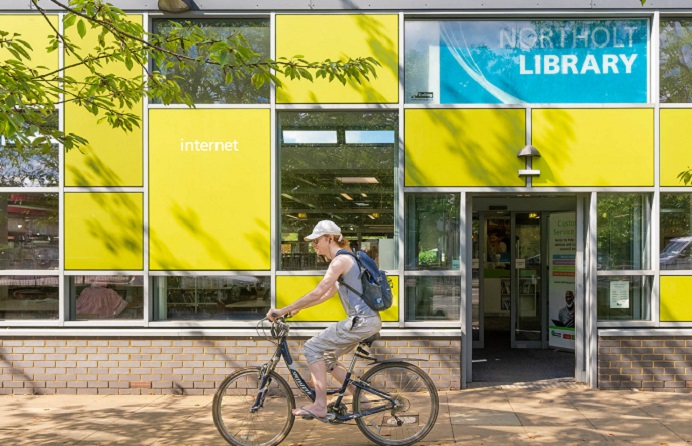 Front of Northolt Library with cyclist riding past