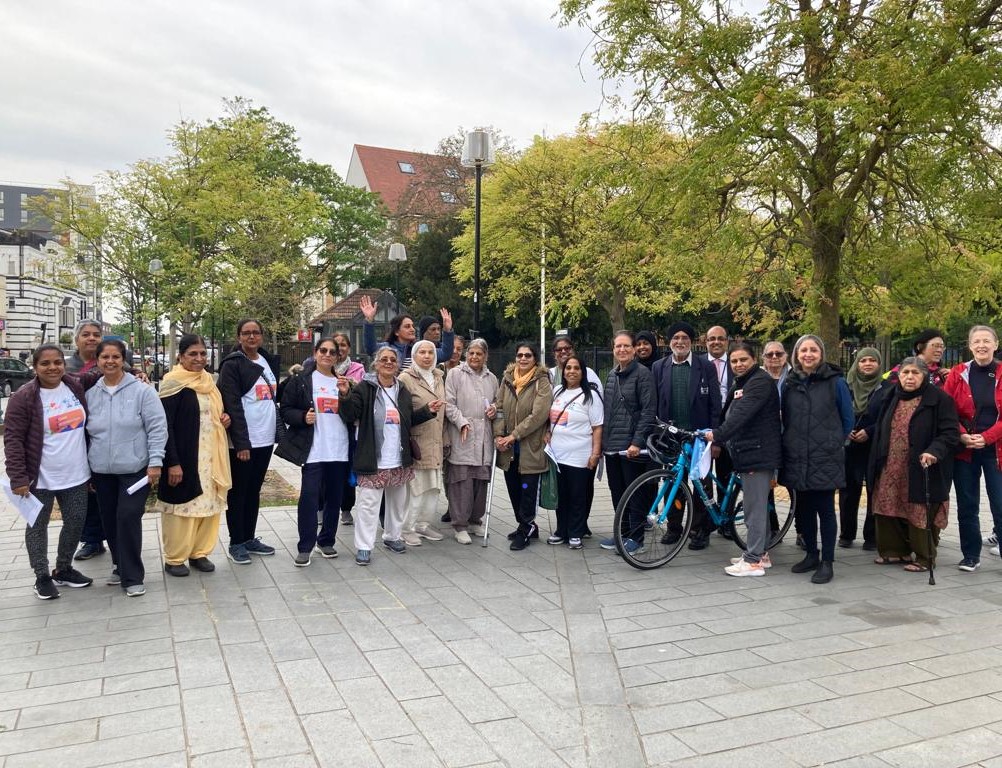 A group of residents - both men and women - gathered at a street in Southall.