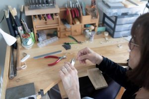 Jewellery maker Alison Crossick using her hand tools