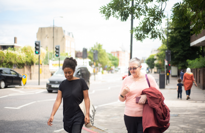 A black woman and a white older woman walking next to each other