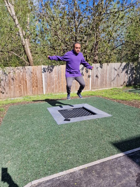 young man jumping on trampoline at short breaks service