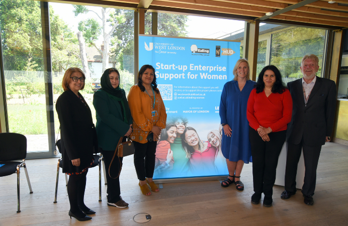People standing in front of a pop up banner promoting Start-up Enterprise Support for Women