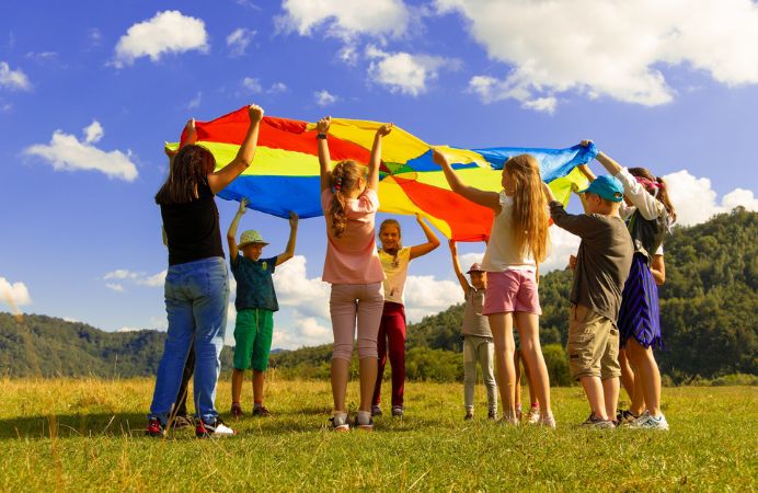 Children on holiday playing in a field