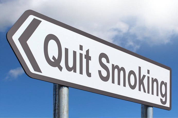Road sign reading Quit Smoking