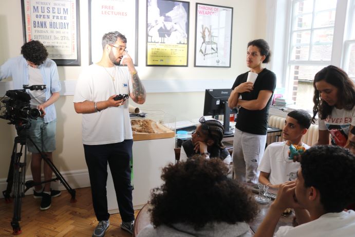 group of young people taking part in filming over a cup of tea