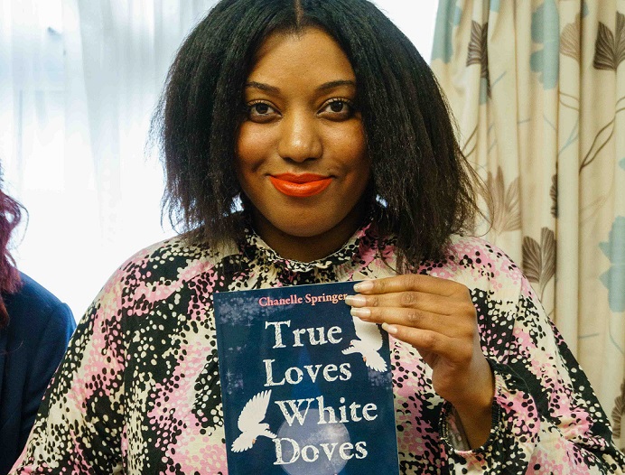 Woman holding book called True Loves White Doves
