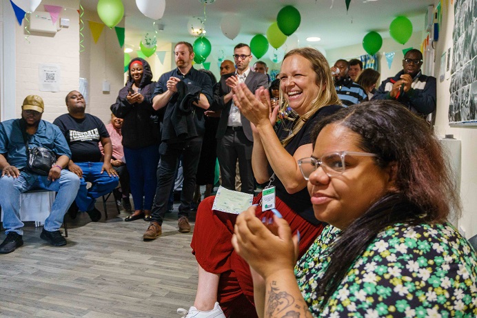 group of people clapping and smiling