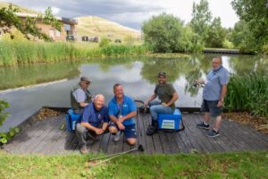 Carl Nye and volunteers fishing at Northala lakes with one of the hills in the background