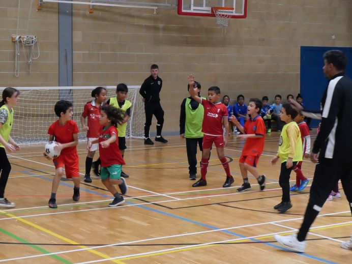 children playing ball sport in school gym