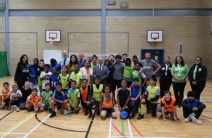 Councillor Nagpal is joined on basketball court to pose for a photo with organisers and attendees.