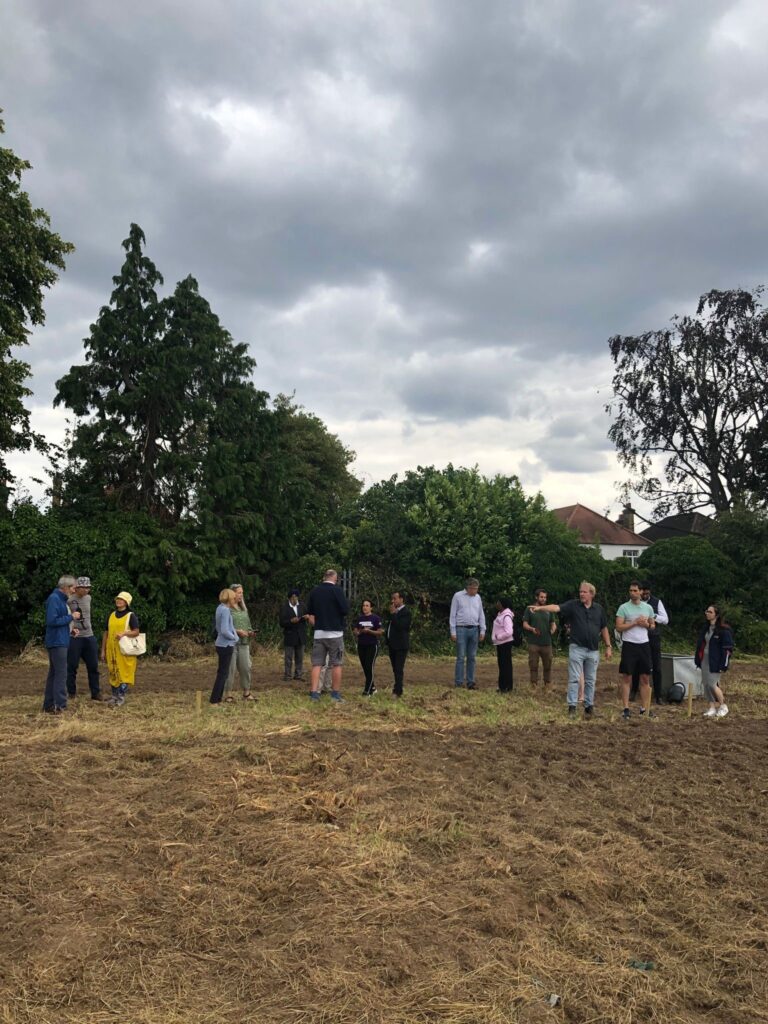 Paul Carter from Ealing Allotment Partnership showing people around the new Popesfield allotment