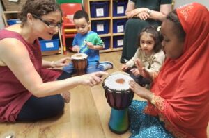 Children with teacher and drum