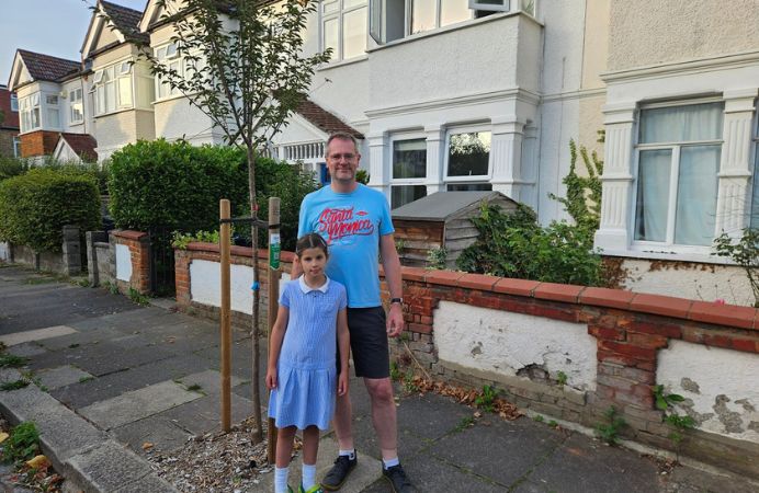 Johan Ditmar and his daughter with tree he sponsored with trees for streets