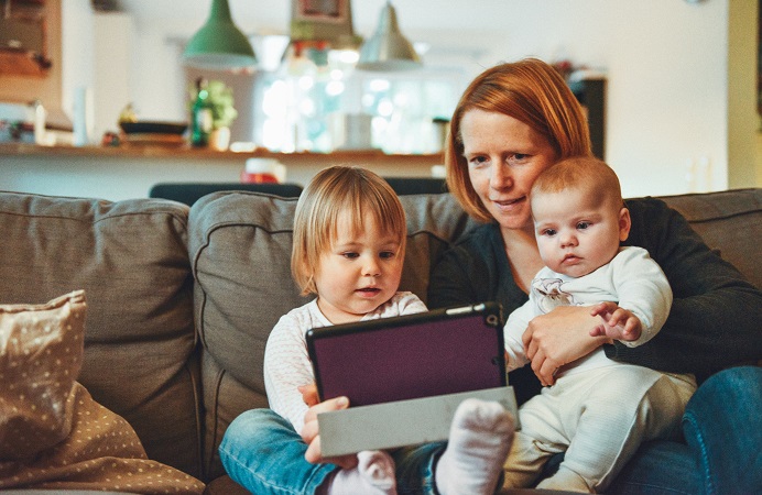 A mum and her children learning with a tablet computer