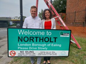 Councillors Mason and Costigan with one of the borough's new signs to tackle anti idling signs