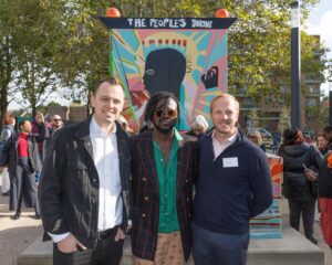 Left to right - Councillor Peter Mason, leader of Ealing Council, Adébayo Bolaji, artist, and another man posting in front of an arts sculpture
