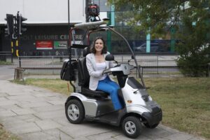 Cllr Costigan tries out MAVIS, the AI mobility vehicle
