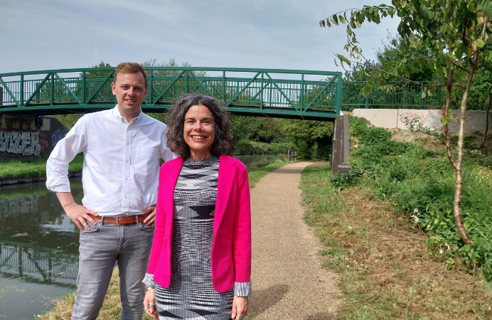 Councillors Mason and Costigan standing in front of the new green bridge.