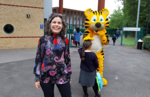 Cllr Costigan with children meeting Terri the Tiger in front of Ravenor primary school