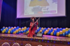 A performer on stage plays traditional Ukrainian instrument