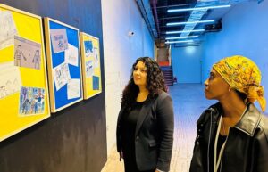 two women viewing children's artwork