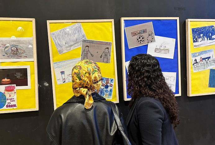 Art exhibition of children's work with two women viewing