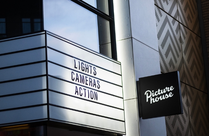Lights, cameras action. The sign in front of the new cinema reads.