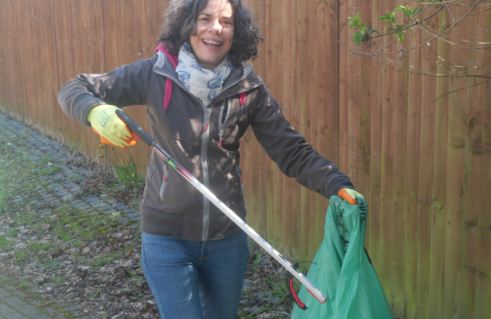 Councillor Costigan picking up litter outdoors