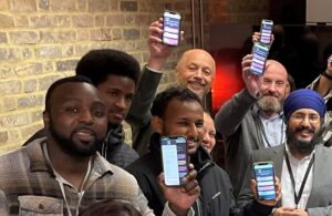 Care leavers and council staff holding up mobile phones displaying the new Ealing Cares app