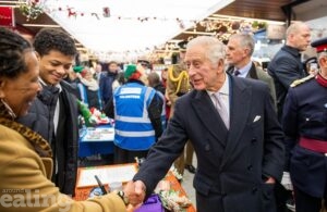 The King shaking hands with market traders during his visit to Ealing Broadway shopping centre, 7th December 2023