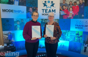 Two women, Helen and Nicky, holding award certificates