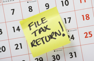 File tax return on a yellow post it note