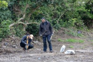 1 man digging abare site at Western Road and 1 man observing