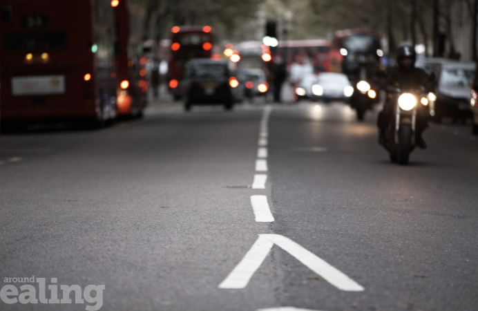 Cars, bus and motorbike on a busy road