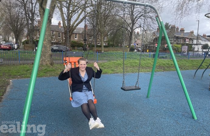Cllr Knewstub tries out swing on one of the renovated playgrounds