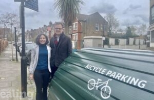 Cllr Mason and Cllr Costigan pose beside 100th bike hanger installed in borough