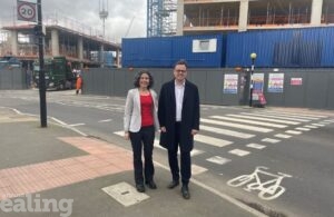 Cllr Mason and Cllr Costigan stand by a road crossing in support of £28m better roads plan