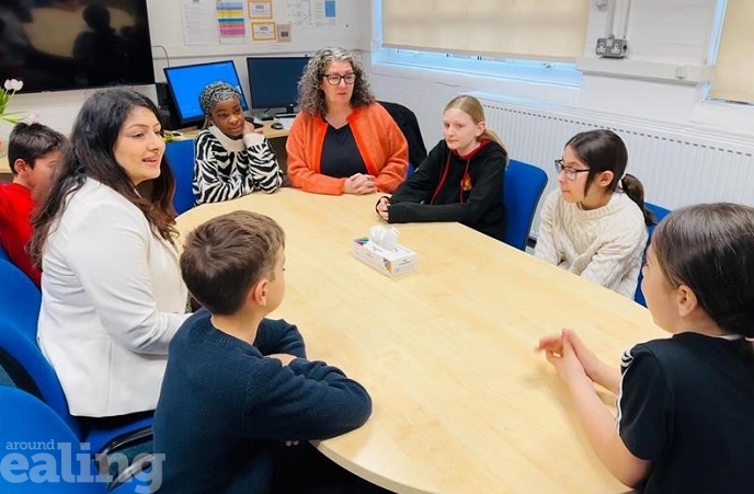 2 adult women and 6 children sitting at a table