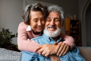 Older man and older woman hugging