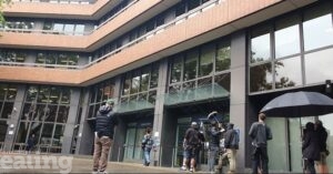 small crowd filming outside Perceval House, Ealing