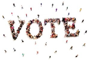 aerial view of people standing to shape the word 'vote'