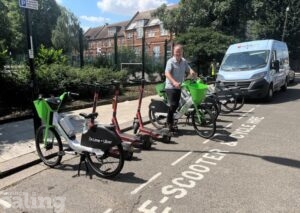 Councillor Paul Driscoll standing with an electric bike,